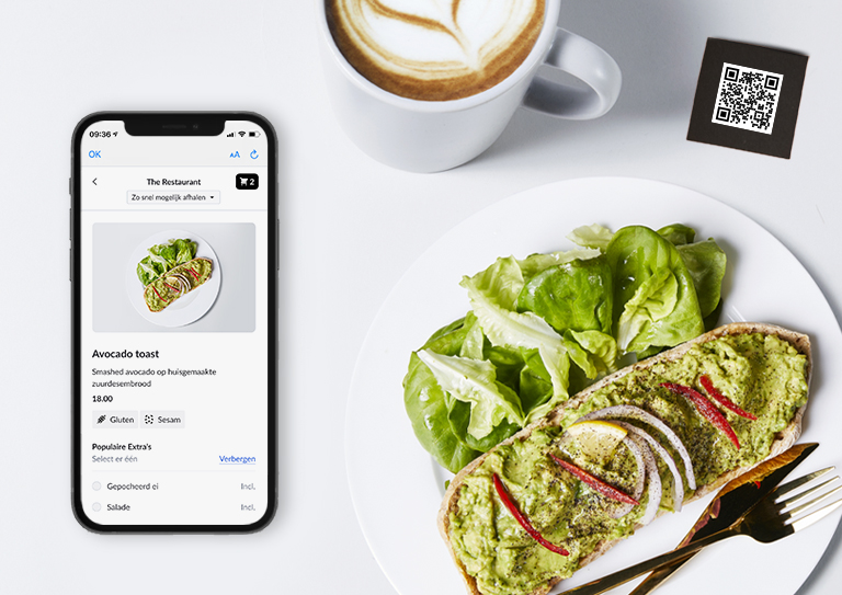 Smartphone met menu, een cappuccino, een QR-code en een slaatje.